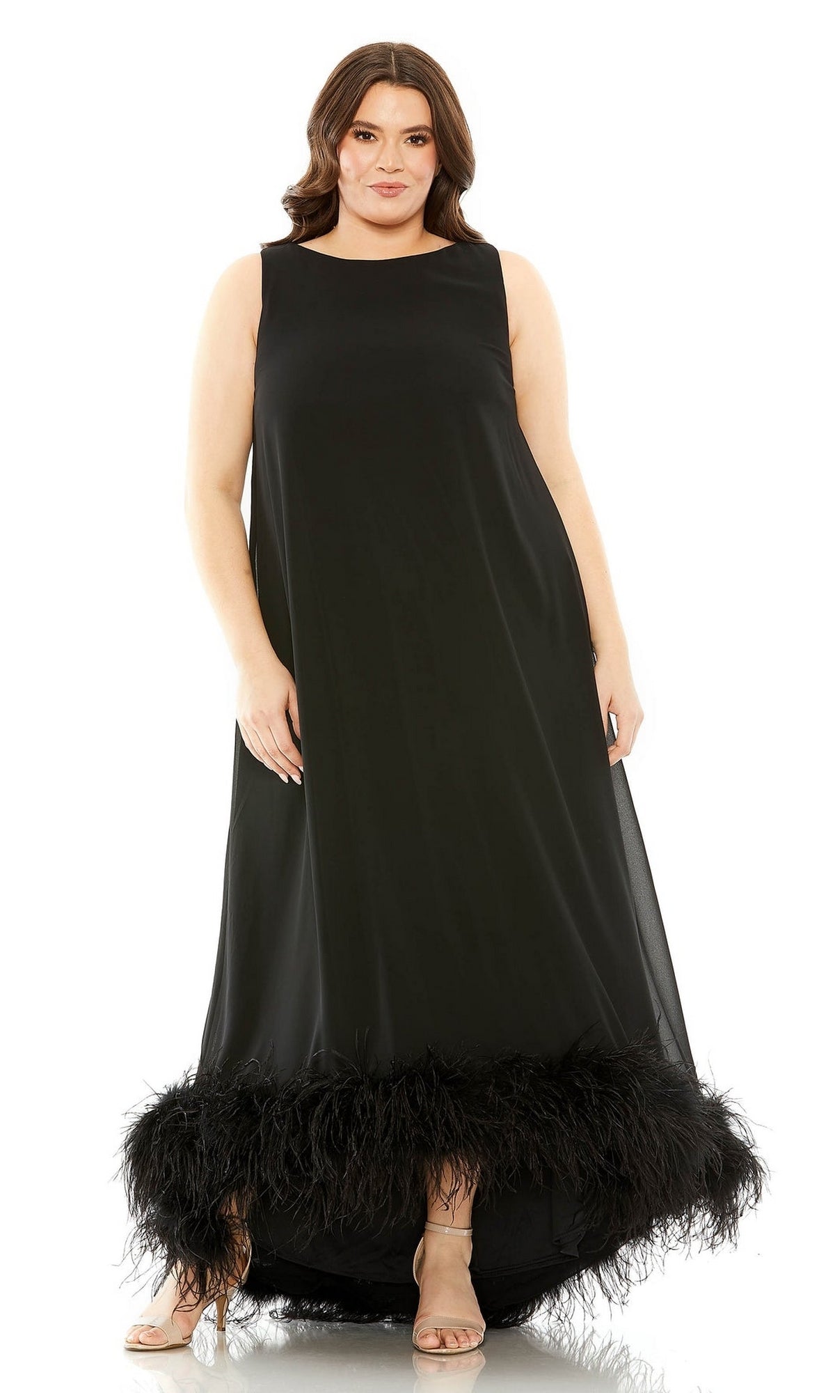 A woman stands facing forward in the Mac Duggal 11819 plus-size long formal dress with a sleeveless design, feathered hem, and open-toe heels.